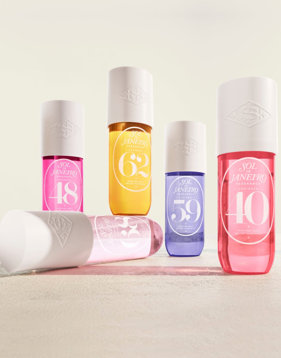 Set of colorful skincare bottles with visible brand name on a light background